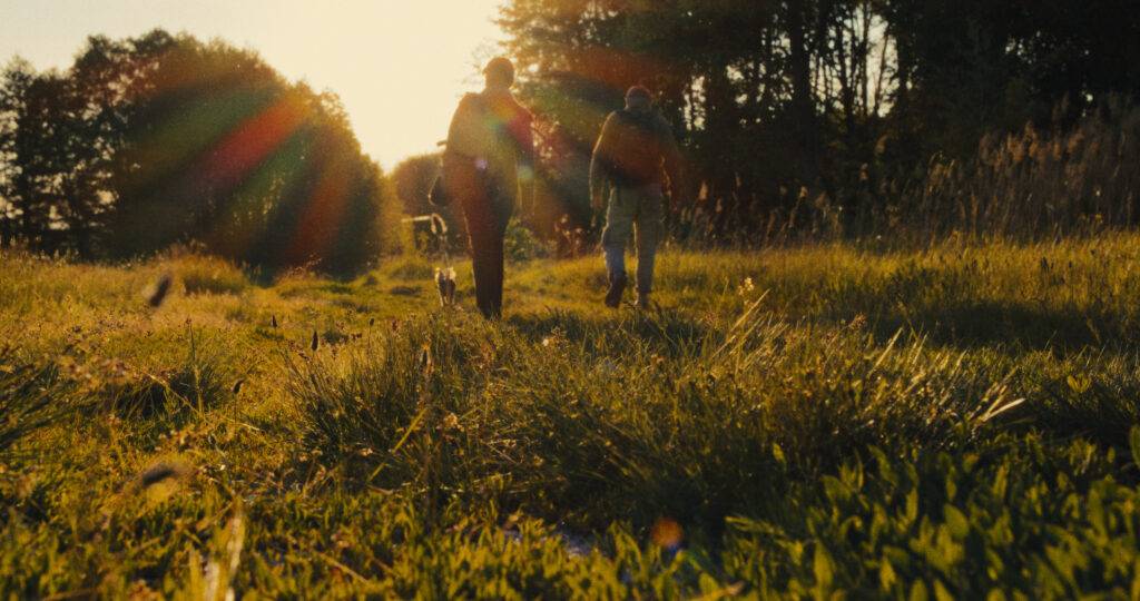 Slava and Anya in field in Porcelain War