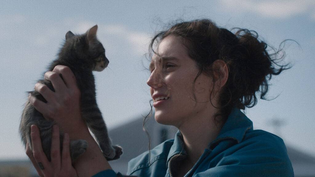 Eva Victor appears in Sorry, Baby by Eva Victor (holding up cat), an official selection of the 2025 Sundance Film Festival. Courtesy of Sundance Institute | photo by Mia Cioffi Henry.