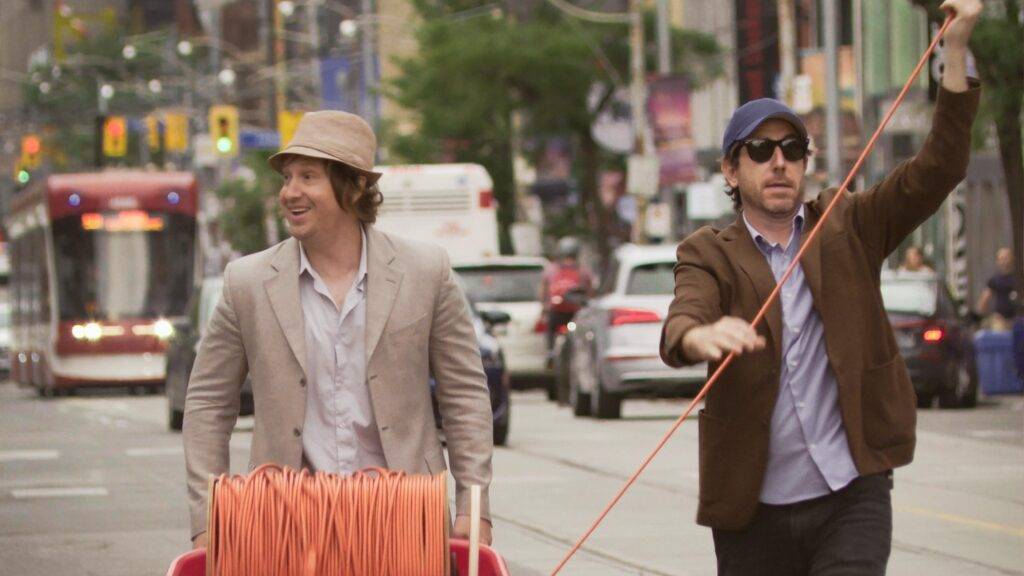 Matt Johnson and Jay McCarrol walking down the street in the movie Nirvanna the Band the Show the Movie