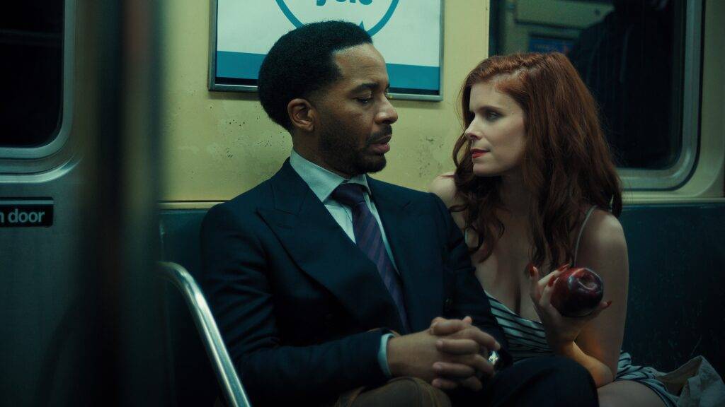 Andre Holland and Kate Mara on a dimly lit train in the movie The Dutchman