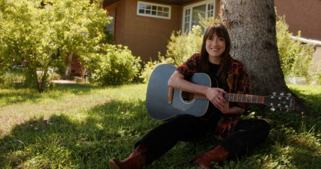 Cassidy Waring with her Guitar in a Promo Still for Hearse Chasing