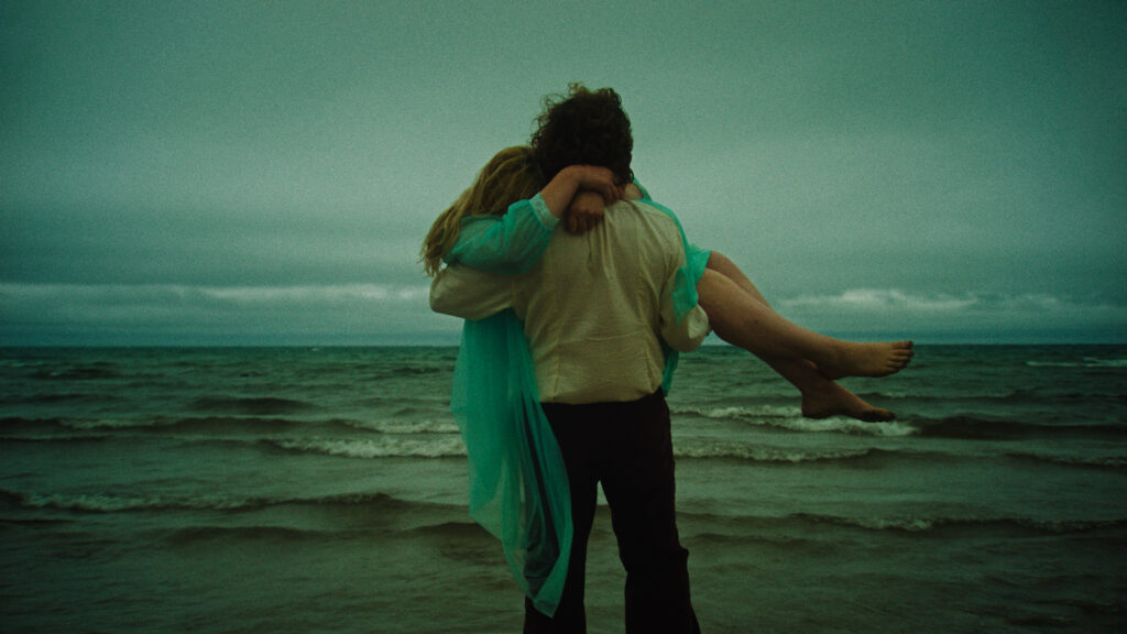 Ben Petrie carrying Grace Glowicki in a still from the film HONEY BUNCH