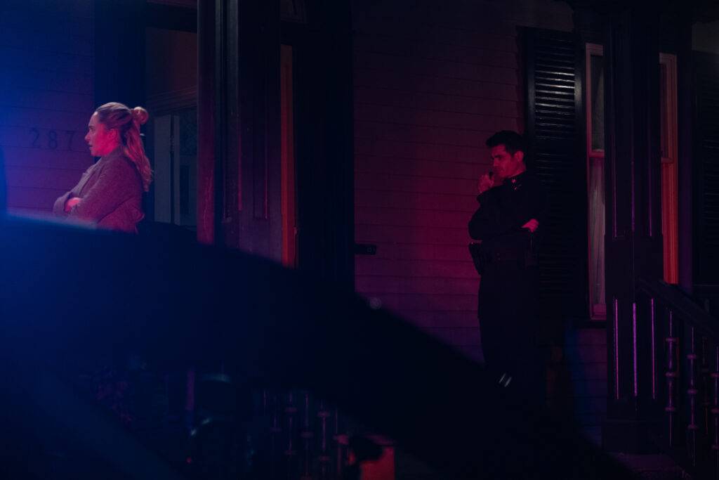 Sleepwalker still: Hayden Panettiere standing outside bathed in police light