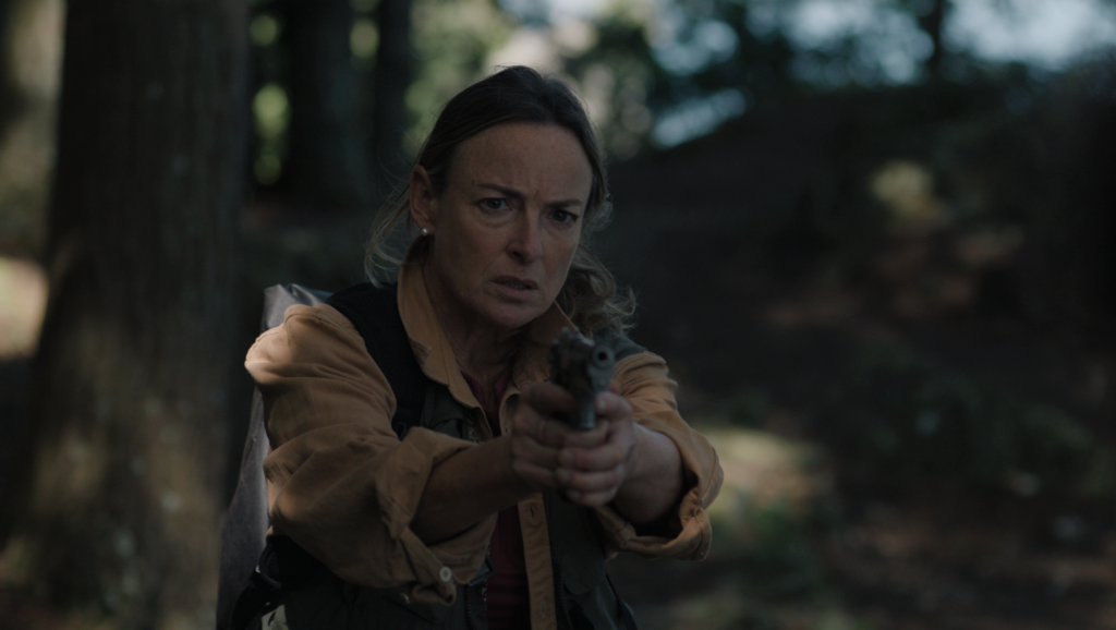 Pascale Bussières holding a gun in the film Someone's Daughter