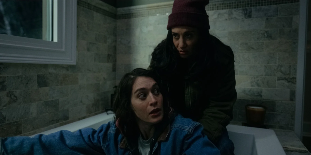 Two women hiding in a bathroom in Drag