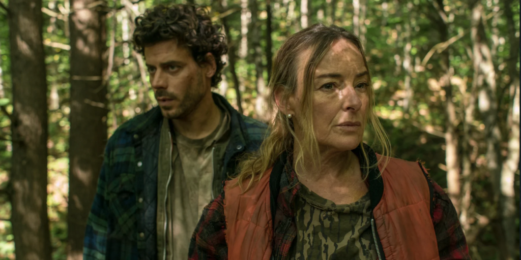 Two people standing in a sunlit forest in Someone’s Daughter