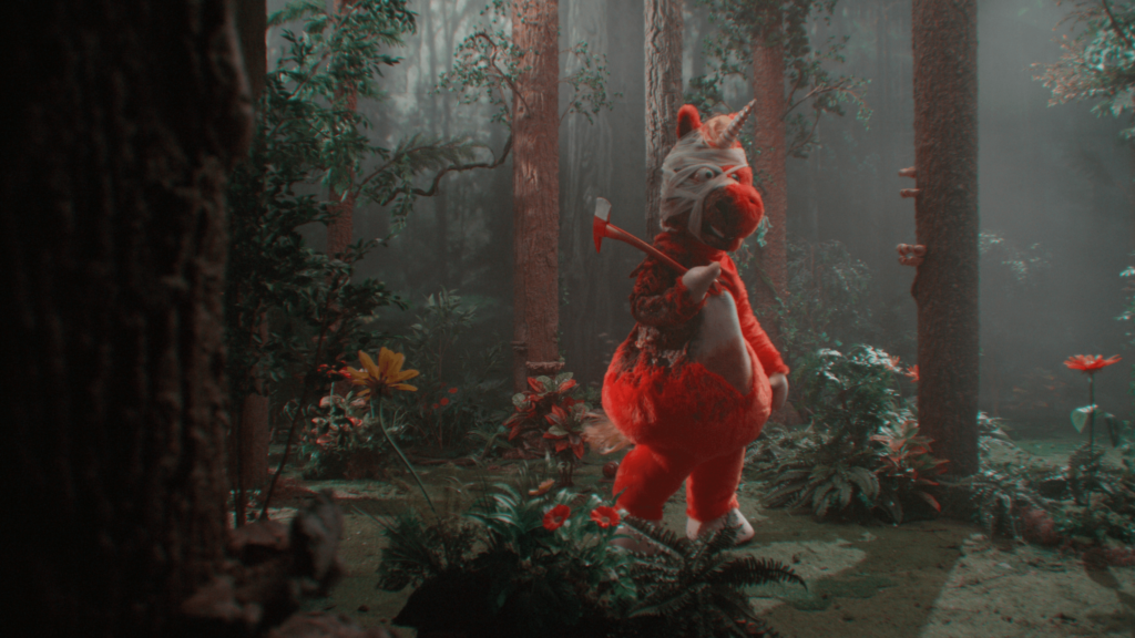 Buddy character from the movie Buddy stands in a forest, bandaged, holding an axe