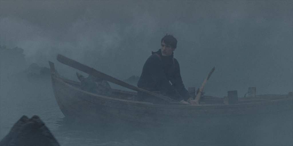 Egor Venned as Baldur rows a wooden boat through dense fog in No Rest for the Wicked