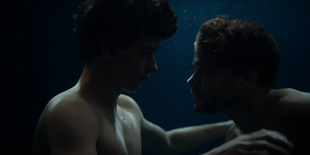 Egor Venned as Baldur and Pilou Asbæk as Helge face each other underwater in No Rest for the Wicked