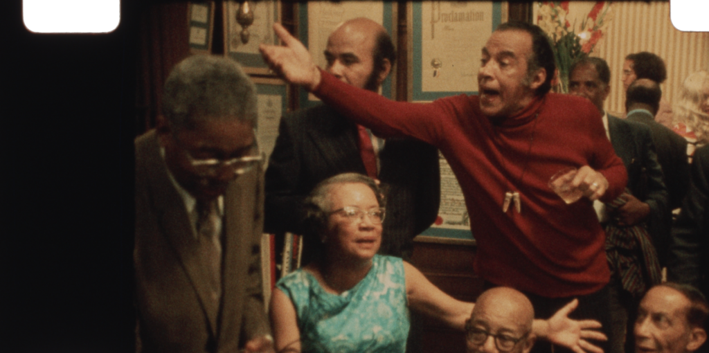 Guests talk and gesture during a crowded 1972 gathering in Once Upon a Time in Harlem